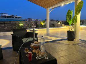 a table with drinks on a patio at night at Suite cobalt suite nova suite évasion in Mostaganem