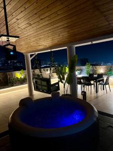 a living room with a hot tub on a patio at Suite cobalt suite nova suite évasion in Mostaganem