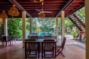 an outdoor dining area with a table and chairs at Sambor Village Hotel in Kompong Thom