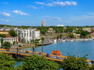 a view of a city with a river and a bridge at Hostal Santa Barbara in Santo Domingo