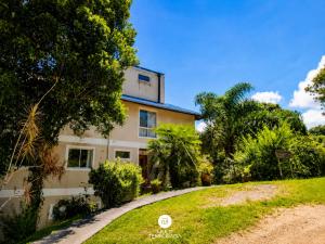 a house on a hill with trees and grass at Pousada Casa do Reiki - Rancho Queimado/SC in Rancho Queimado