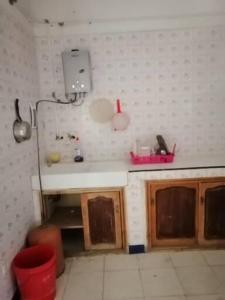 a small kitchen with a sink and a counter at Akr appartement in Al Hoceïma