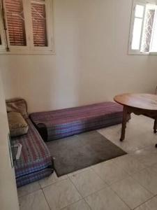 a living room with a couch and a table at Akr appartement in Al Hoceïma