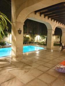 a patio with a swimming pool under a building at Heaven new Cairo Villa with Private pool and jacuzzi in Cairo