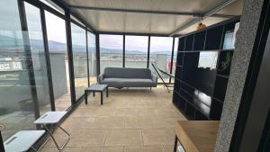 a living room with a couch and a chair at Valença RoofTop by Beeflats BnB in Valença