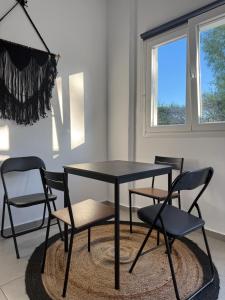 a black table and chairs in a room at Coconut beach villas 5 in Schinias