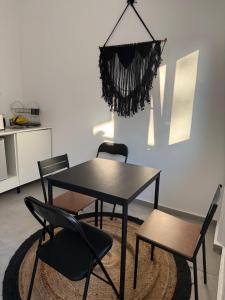 a dining room with a table and two chairs at Coconut beach villas 5 in Schinias