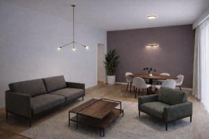 a living room with a couch and a table at A1 HighTown Aprtmnt, Steps frm Luton Train Station in Luton