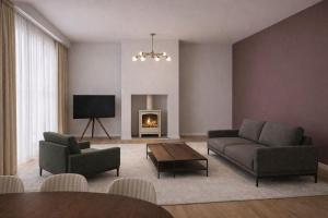 a living room with two couches and a fireplace at A1 HighTown Aprtmnt, Steps frm Luton Train Station in Luton
