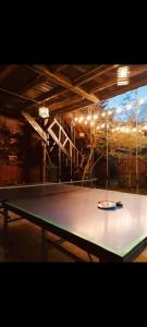 a ping pong table in a room with a ping paddle at Cabaña en la Calera con Sauna in La Calera