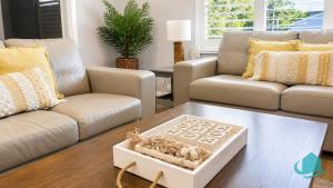 a living room with a couch and a table at Castaway at Pelican in Pelican Flat