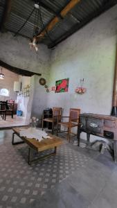 a living room with a table and a stove at Kallpa Warmi in San Antonio