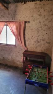 a room with a pool table and a window at Kallpa Warmi in San Antonio