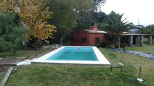 a swimming pool in a yard next to a house at Kallpa Warmi in San Antonio