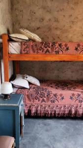 a bedroom with a wooden bunk bed with pillows at Kallpa Warmi in San Antonio +12 photos