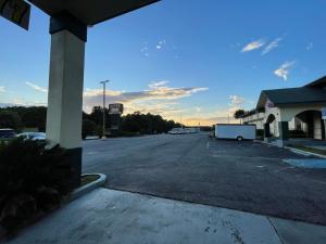 an empty parking lot in front of a gas station at Super Inn And Suites in Milledgeville