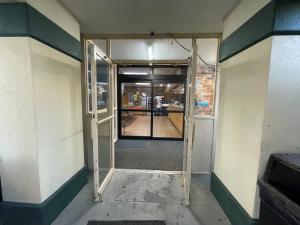 an empty hallway with a door in a building at Super Inn And Suites in Milledgeville