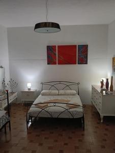 a bedroom with a bed and two tables and a lamp at Simbilis B&B Holiday Experience Mimose in Quartu SantʼElena