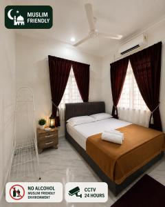 a bedroom with a large bed with red curtains at UZ Jerteh Inn in Jertih