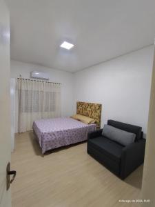 a living room with a bed and a couch at Pousada Relicário in Nova Petrópolis