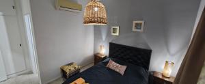 a bedroom with a bed and a chandelier at Nuestra Recova 2 en Pilar BsAs in Pilar +22 photos