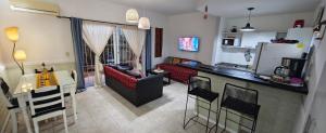 a kitchen and living room with a couch and a table at Nuestra Recova 2 en Pilar BsAs in Pilar