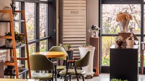 a room with chairs and a table and a window at Gapyeong Hue 910 Pension in Gapyeong