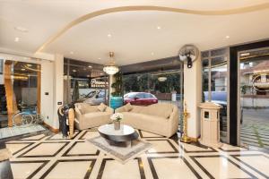 a living room with two couches and a table at Paramount Residency in Nedumbassery