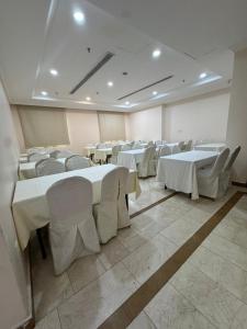 a large room with tables and chairs in it at فندق فيفيان الجميزة in An Naqāʼ