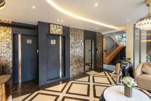 a lobby with a staircase and a room with blue doors at Paramount Residency in Nedumbassery