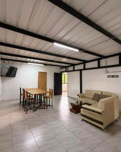 a living room with a table and a couch at Refugio raices in Guarne