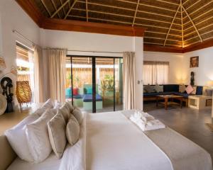 a bedroom with a white bed and a living room at Villa Kasadya in Panglao Island +73 photos