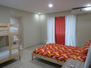 a bedroom with a bed and a bunk bed at Yara Hotel in Punta Cana