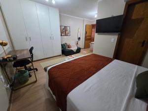 a bedroom with a large bed and a couch at Studio Sudoeste Ed Multiparque in Brasília