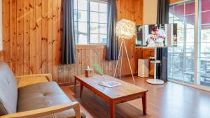 a living room with a couch and a table at Yangpyeong Narinsoom Private Villa in Yangpyeong