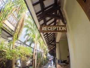 a sign that reads reception on the side of a building at Blue Marlin Dive Resort Trawangan in Gili Trawangan