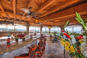 a restaurant with a long bar with chairs and flowers at Casa Grande Luxury Boutique Hotel in San Miguel de Allende