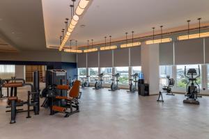 a gym with treadmills and exercise equipment in a building at Pullman Kuching in Kuching
