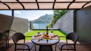 a table on a balcony with a bottle of wine at Chuncheon Rabbit Star Pension in Chuncheon