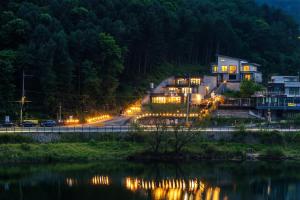 a house on the side of a road at night at Chuncheon Rabbit Star Pension in Chuncheon