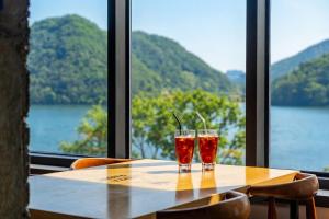 two glasses sitting on a table in front of a window at Chuncheon Rabbit Star Pension in Chuncheon +2 photos