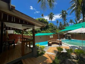 a resort with a swimming pool and a patio at Backpackers & Event Lounge in Valencia