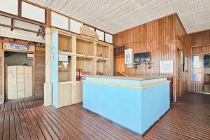 an empty room with a counter in a building at RedDoorz at Derawan Beach Cottage in Derawan Islands