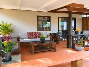 a living room with a couch and a table at Sunset Palms Rarotonga in Rarotonga