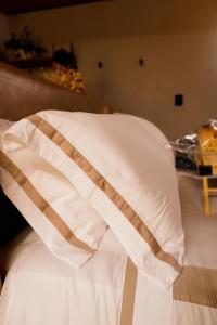a close up of a bed with a white pillow at Moldavite Bungalow in Treze Tílias +13 photos
