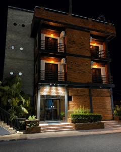 a brick building at night with its lights on at Altura525 hotel in Jarabacoa +11 photos