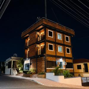 a tall brick building with lights on it at night at Altura525 hotel in Jarabacoa