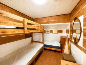 a room with two bunk beds and a mirror at おきなわ民泊海族 in Okinawa City