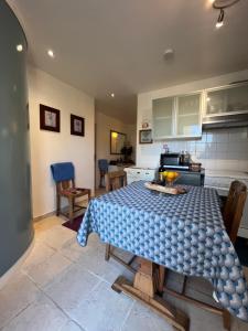 a kitchen with a table in the middle of it at St Pasha in Paillé