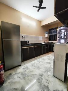 a kitchen with a refrigerator and a ceiling fan at Casa Santana in Dabolim